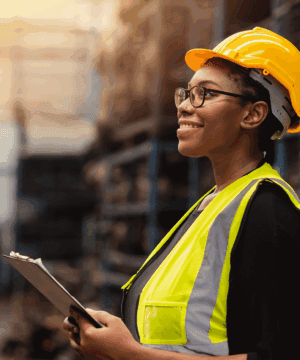 a woman wearing a yellow hard hat and safety vest