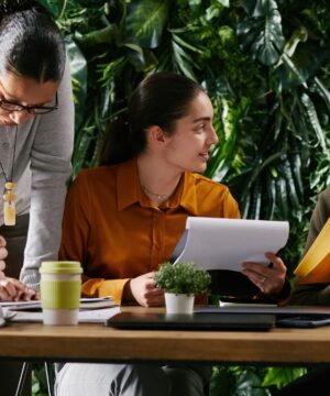 A group of professionals are sitting together to discuss ICHRA