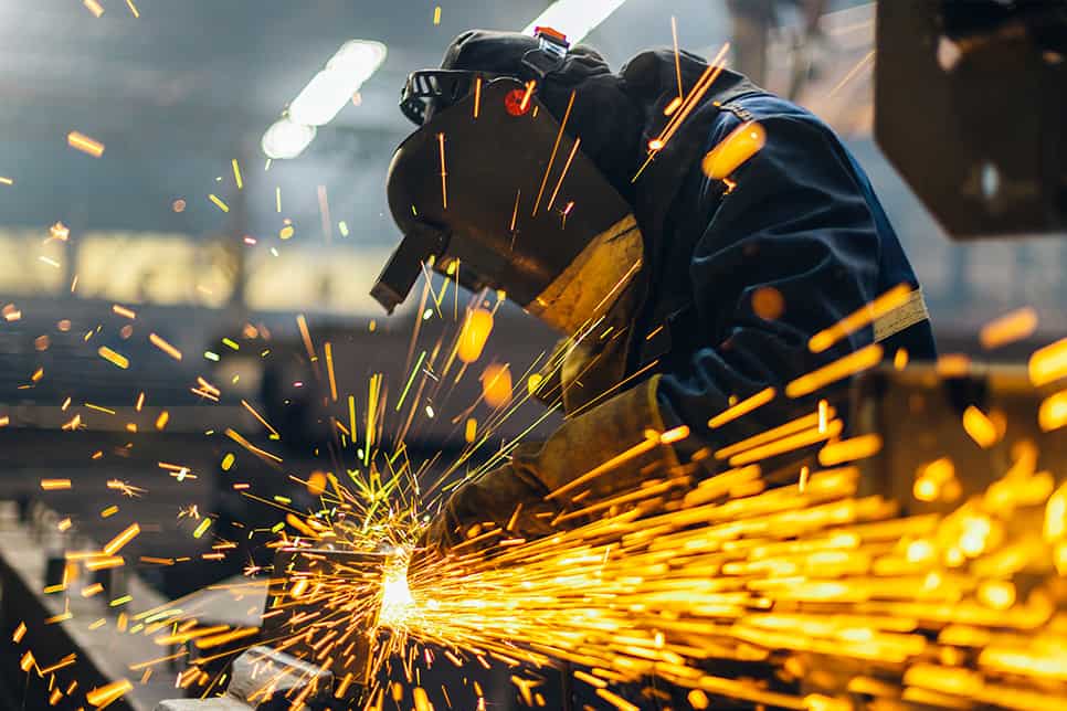 welding professional works on fabricating and manufacturing