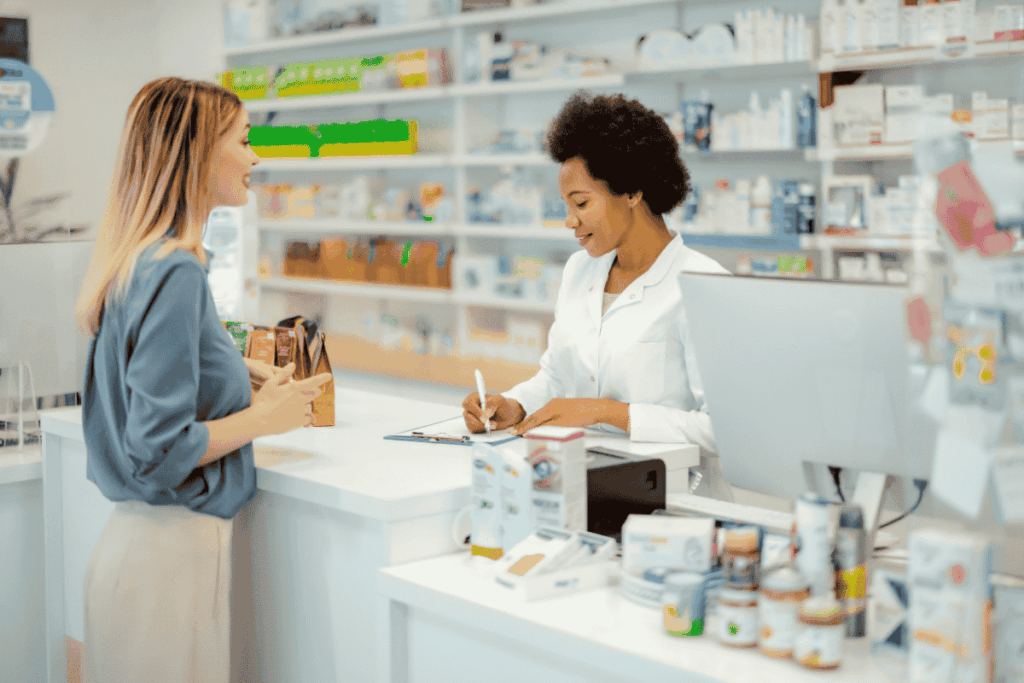 image of pharmacist and patient at pharmacy counter