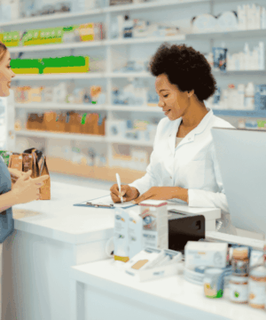 image of pharmacist and patient at pharmacy counter