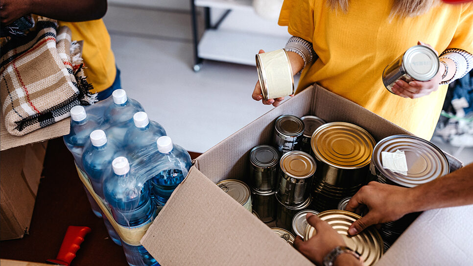 volunteers at food bank gather food for those in need or that aren't paid a living wage by the corporations they work for