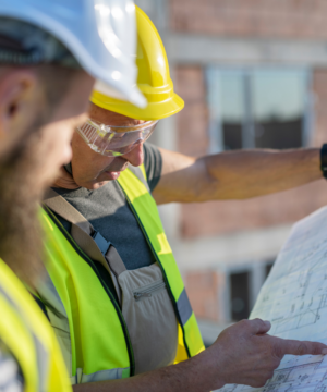 construction workers looking at a blue print
