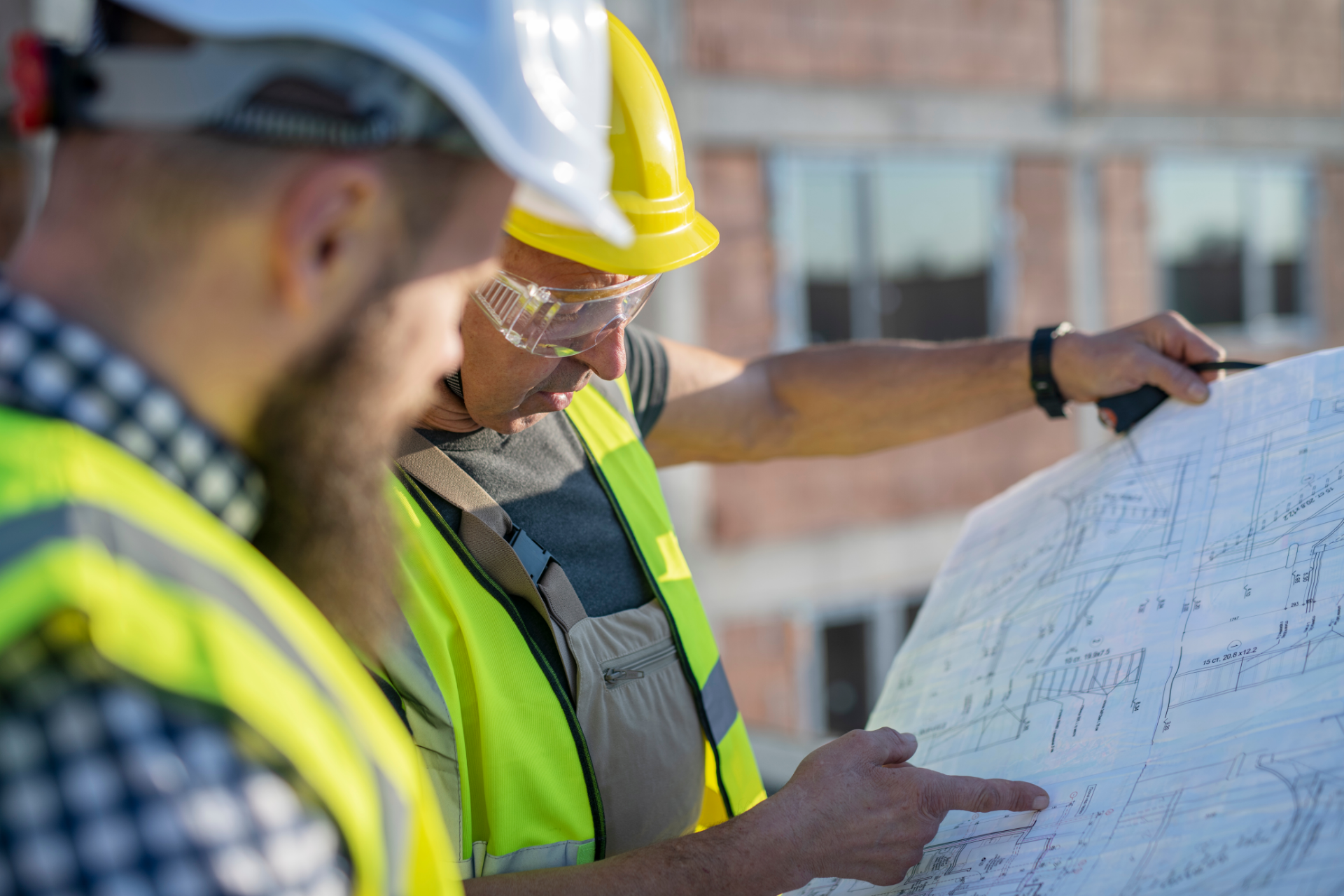 construction workers looking at a blue print